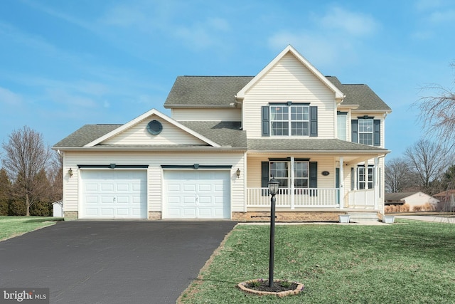 traditional-style home featuring a front yard, driveway, roof with shingles, covered porch, and a garage