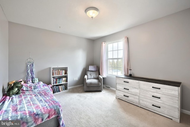 carpeted bedroom with visible vents and baseboards