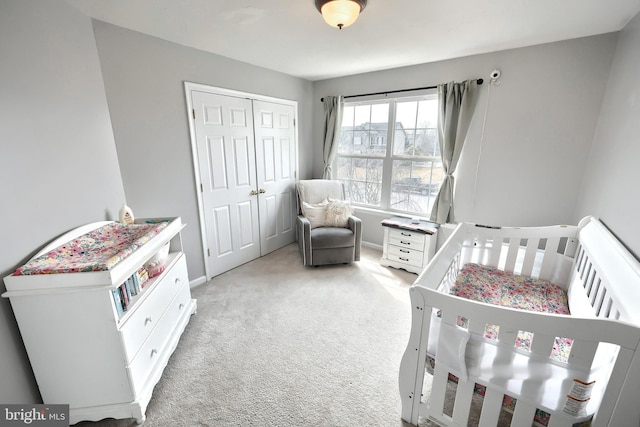 bedroom featuring a closet and light carpet