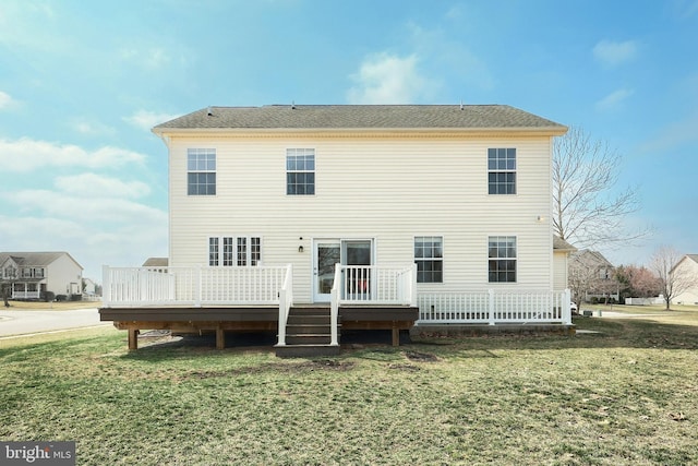 back of property featuring a yard and a deck