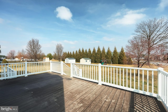 deck featuring an outbuilding and a shed