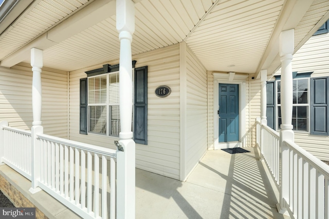 view of exterior entry featuring a porch