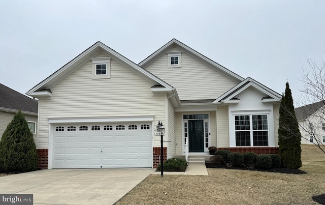 view of front of house with an attached garage, brick siding, and driveway