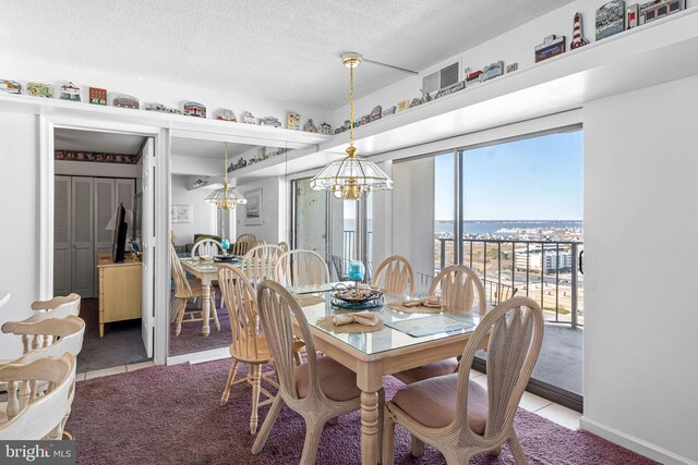 9400 Coastal Hwy Unit 1901, Ocean City, MD 21842 - dining area featuring tile patterned flooring, a notable chandelier, and a textured ceiling