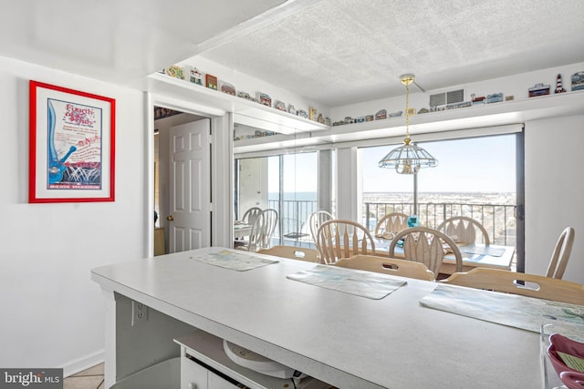 9400 Coastal Hwy Unit 1901, Ocean City, MD 21842 - kitchen featuring baseboards, visible vents, hanging light fixtures, a textured ceiling, and a chandelier