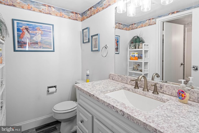 9400 Coastal Hwy Unit 1901, Ocean City, MD 21842 - bathroom with toilet, wood finished floors, an inviting chandelier, baseboards, and vanity
