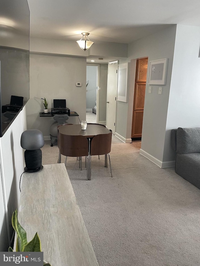 carpeted home office featuring baseboards