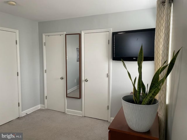 bedroom featuring carpet and baseboards