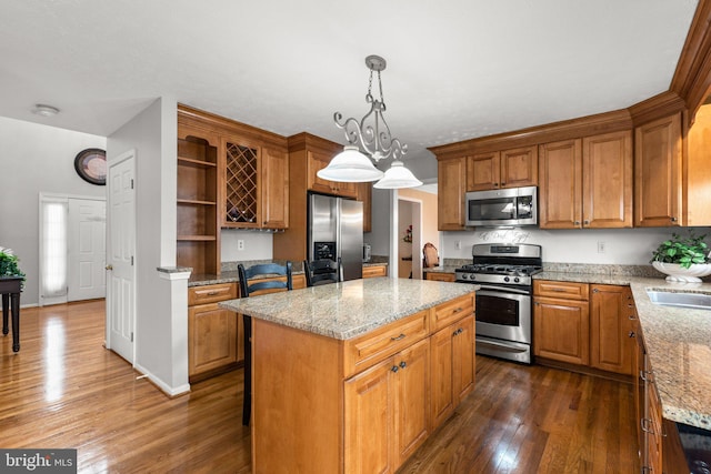 kitchen featuring a center island, dark wood-type flooring, light stone countertops, appliances with stainless steel finishes, and open shelves