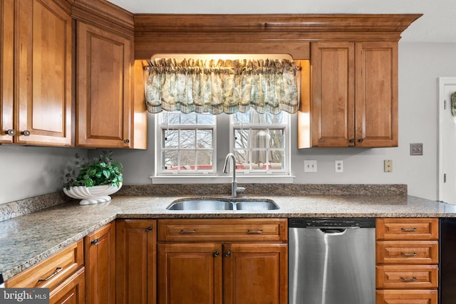 kitchen featuring a sink, dishwasher, and brown cabinetry