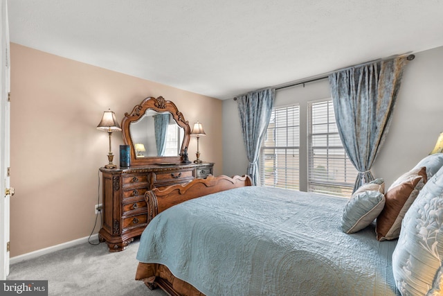 carpeted bedroom with baseboards