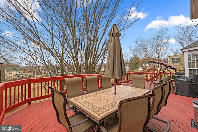 wooden deck featuring outdoor dining space