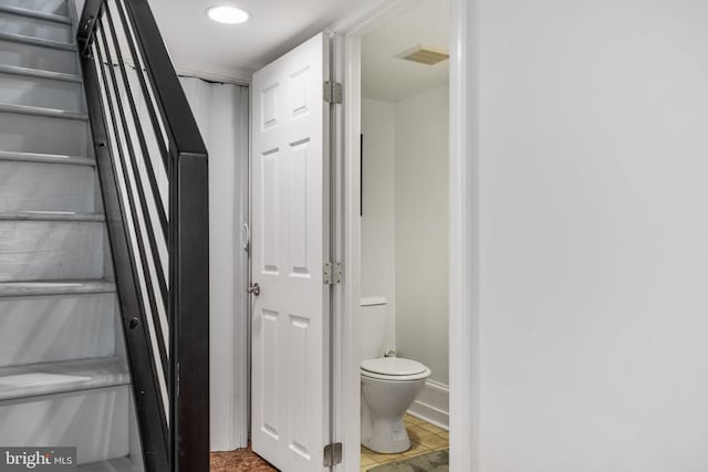 bathroom with toilet and visible vents