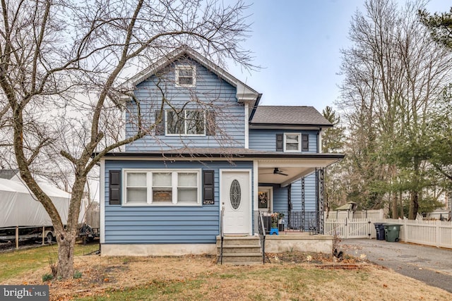 view of front of property with driveway, a gate, fence, covered porch, and ceiling fan