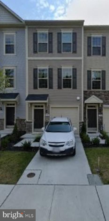 townhome / multi-family property with concrete driveway and an attached garage