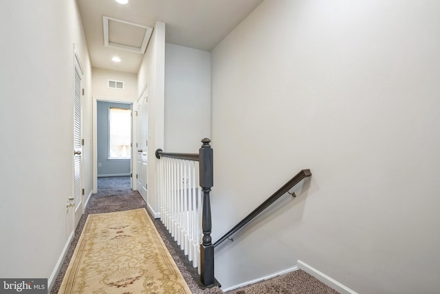 hall with baseboards, an upstairs landing, and carpet flooring