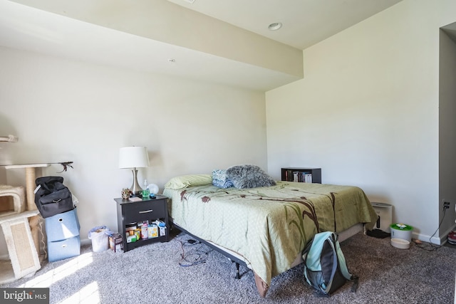bedroom featuring baseboards and carpet
