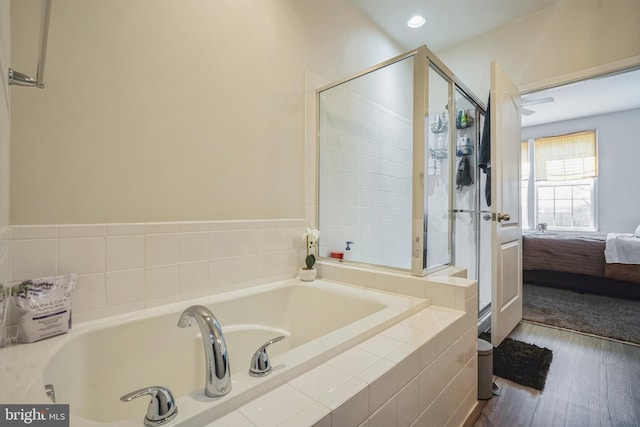ensuite bathroom with wood finished floors, ensuite bathroom, a tile shower, and a bath