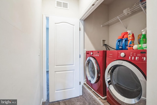 washroom featuring visible vents, independent washer and dryer, and laundry area