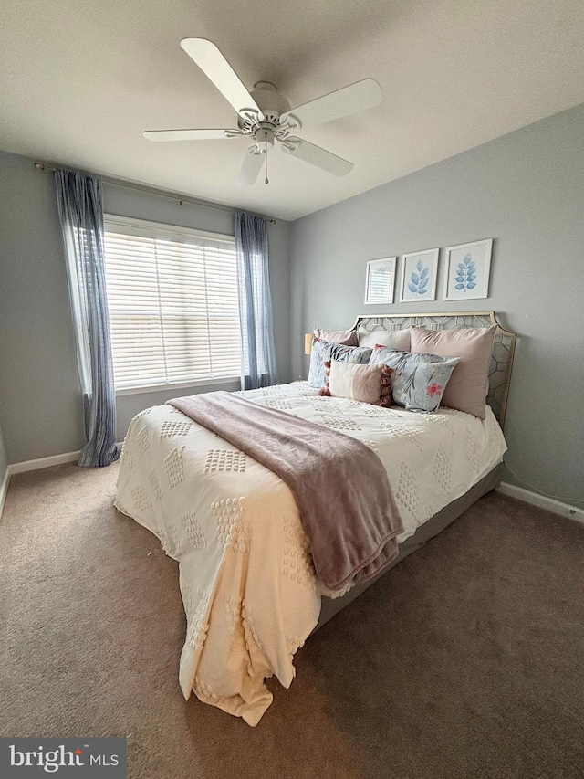 bedroom with a ceiling fan, baseboards, and carpet floors