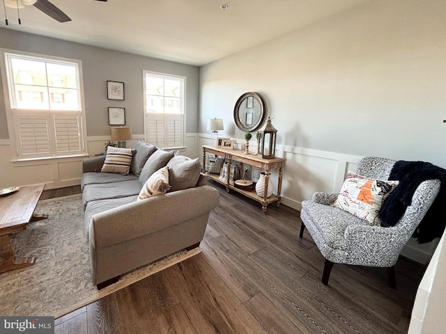 living room with wainscoting, a ceiling fan, and wood finished floors