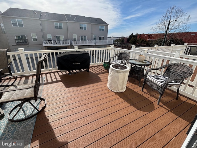 wooden terrace with a grill