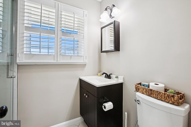 full bathroom featuring baseboards, toilet, a stall shower, and vanity