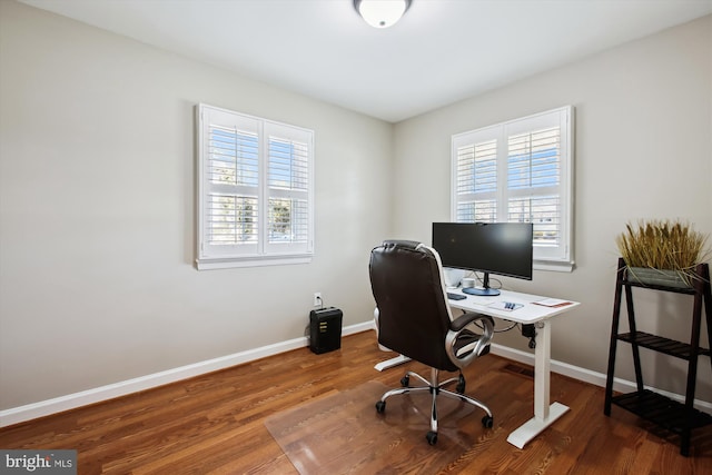 office with visible vents, baseboards, and wood finished floors