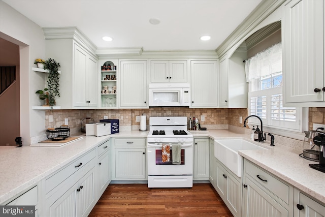 kitchen with white appliances, dark wood finished floors, open shelves, a sink, and tasteful backsplash