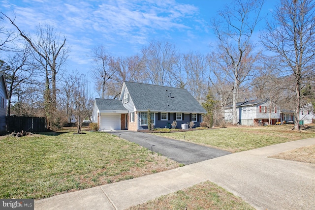 new england style home with a shingled roof, fence, aphalt driveway, a front yard, and a garage