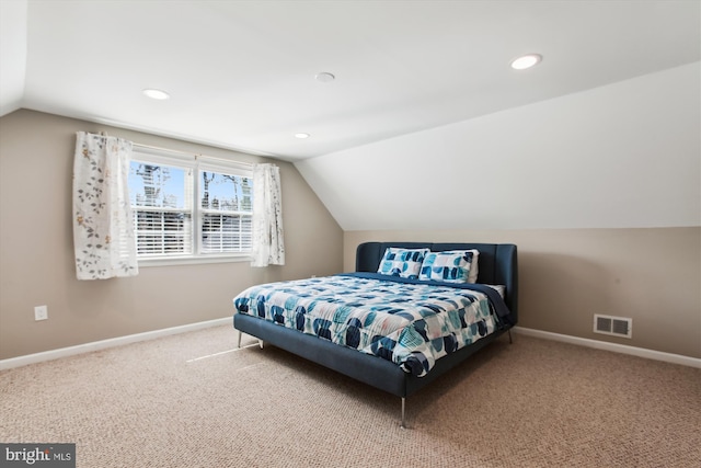 bedroom featuring visible vents, lofted ceiling, carpet, and baseboards