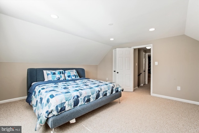 bedroom with lofted ceiling, light colored carpet, and baseboards