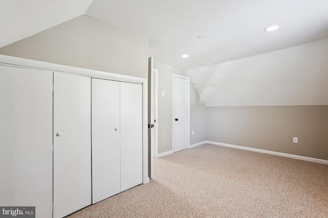 additional living space featuring recessed lighting, light colored carpet, baseboards, and vaulted ceiling