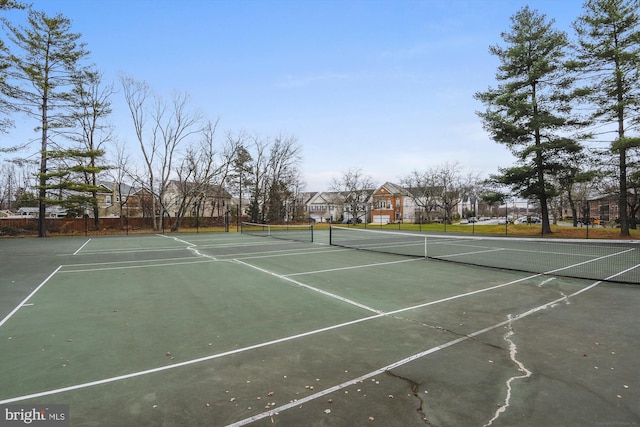 view of sport court featuring fence