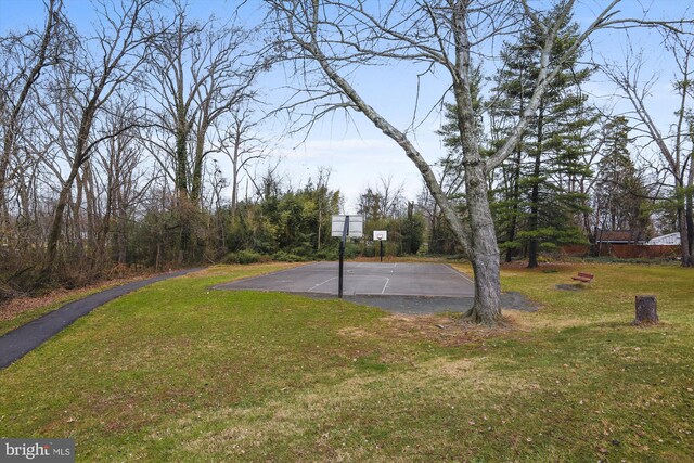 view of basketball court featuring community basketball court and a yard