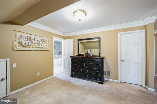 carpeted bedroom featuring visible vents, connected bathroom, baseboards, and ornamental molding