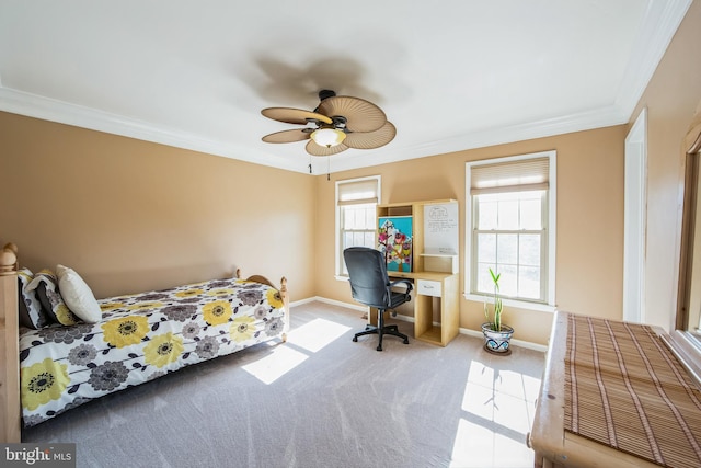 carpeted bedroom with baseboards, ceiling fan, and crown molding