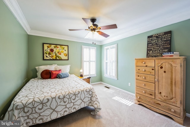 bedroom with baseboards, light carpet, ceiling fan, and crown molding