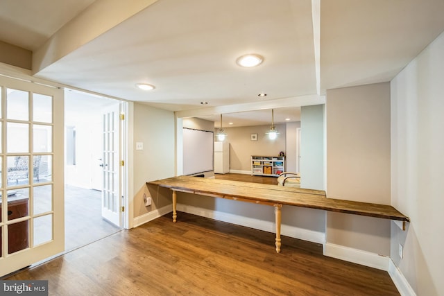 interior space featuring recessed lighting, french doors, baseboards, and wood finished floors