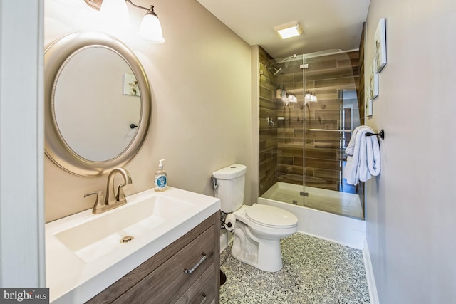 full bathroom featuring toilet, a stall shower, and vanity