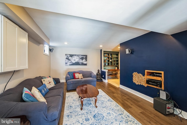 living room with recessed lighting, baseboards, and wood finished floors