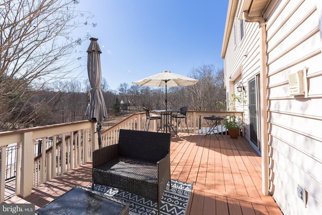 wooden terrace with outdoor dining space