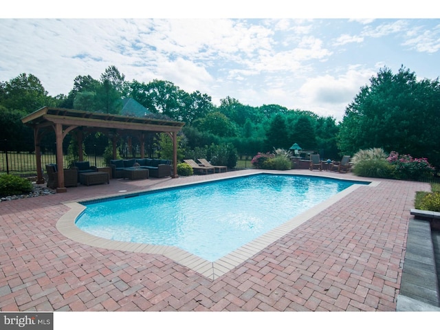 view of pool featuring a patio, a fenced in pool, and an outdoor hangout area