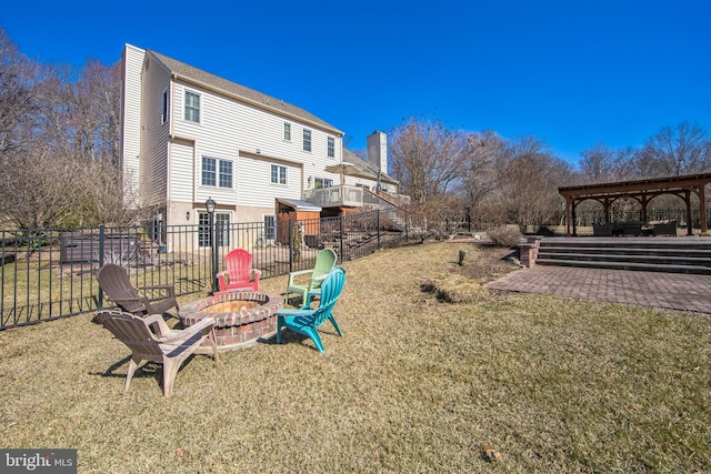 view of yard with a patio area, fence, and an outdoor fire pit