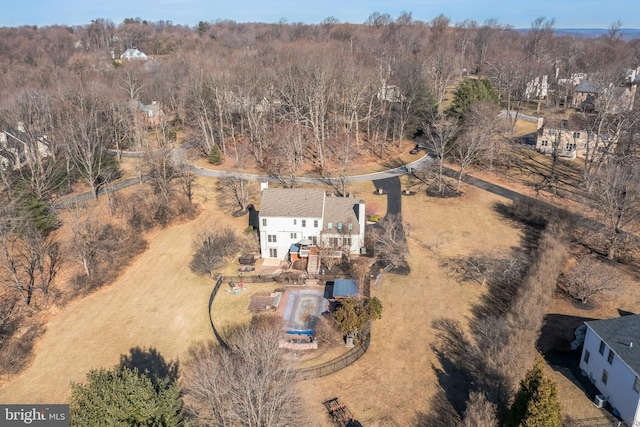 birds eye view of property with a forest view