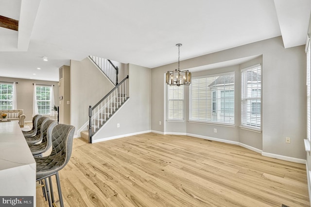 interior space with baseboards, a chandelier, stairs, light wood-type flooring, and recessed lighting