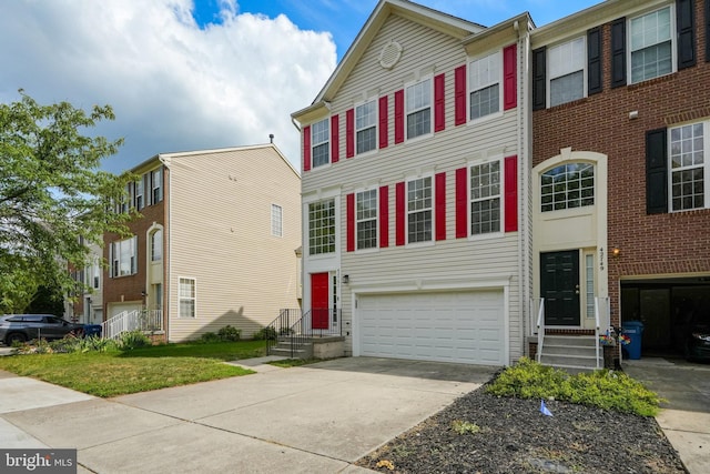 view of property with a garage and driveway