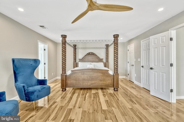 bedroom featuring visible vents, baseboards, light wood-style flooring, and a ceiling fan