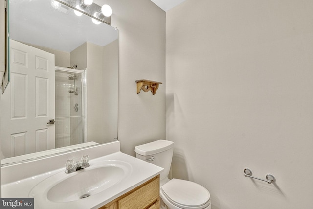 full bathroom with a shower stall, toilet, and vanity