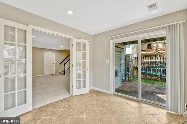 doorway to outside featuring tile patterned floors, visible vents, french doors, carpet flooring, and stairs